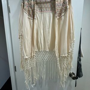 Cream/multi pastel poncho/wrap with fringes.  Very cool.  Never worn